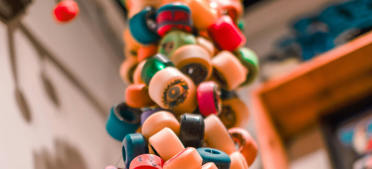 Well-used skateboard wheels hanging in a skate shop